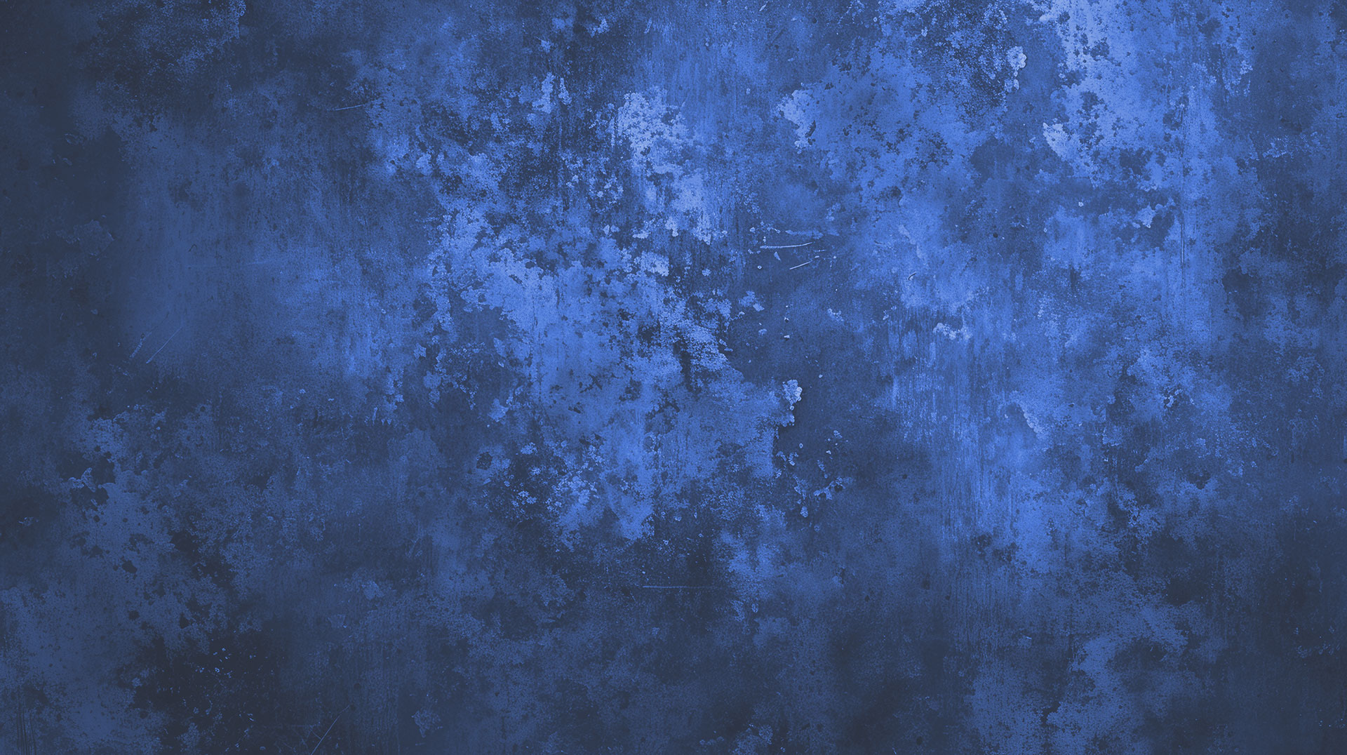 The image displays a textured blue background with a pattern that resembles a starry sky or a close-up of a speckled surface, and to the right is a portion of a gray wall.
